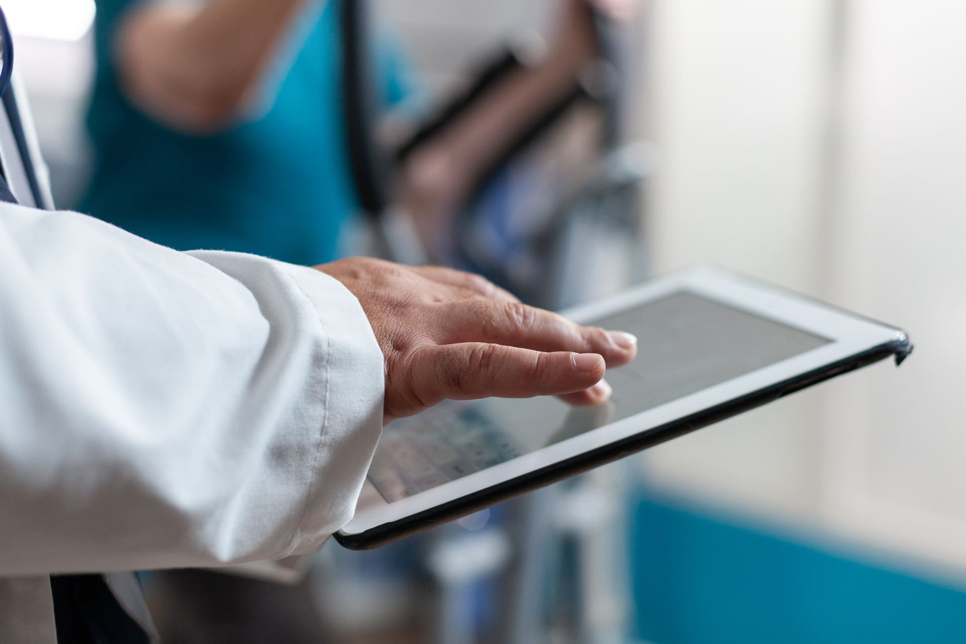close-up-doctor-using-digital-tablet-with-touch-screen